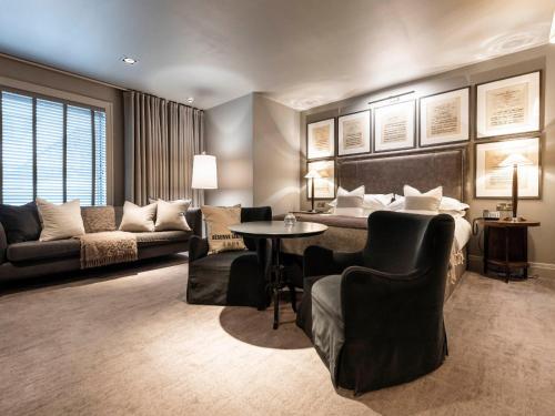 a hotel room with a bed and a table and chairs at Dakota Leeds in Leeds