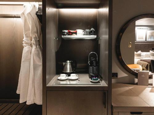 a small kitchen with a coffee maker in a hotel room at Dakota Leeds in Leeds