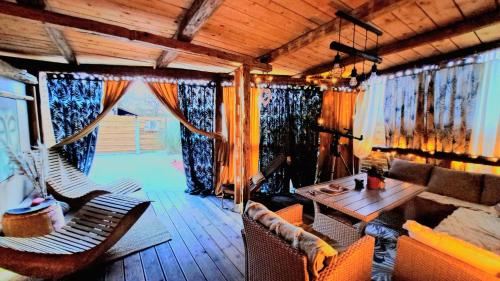 a living room with a couch and chairs and a table at Mobile Home Cabana with HotTub&Sauna in Spodnja Polskava