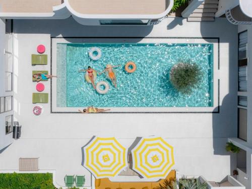 an overhead view of a swimming pool with two people in it at Maldives Beach Resort in Chao Lao Beach