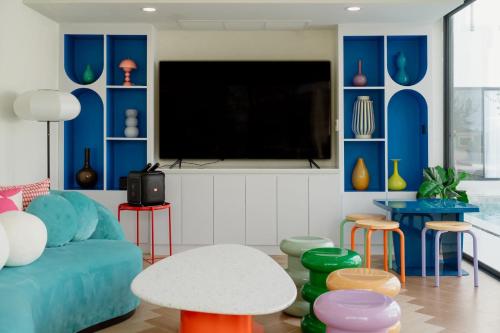 a living room with a blue couch and a tv at Maldives Beach Resort in Chao Lao Beach