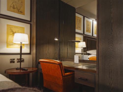 a bedroom with a desk with a lamp and a bed at Dakota Leeds in Leeds