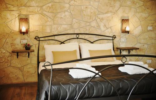 a bedroom with a bed and a stone wall at Menhir in Olmedo