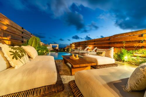 a hotel patio with two beds and a pool at Villa Kintana - Piscine - SPA - Prestations 5 Etoiles in Petite Île