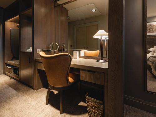 a bedroom with a desk with a chair and a bed at Dakota Manchester in Manchester