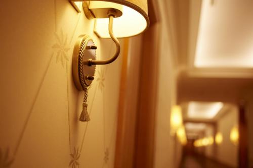 a telephone hanging on a wall in a room at Imperial Hotel Osaka in Osaka