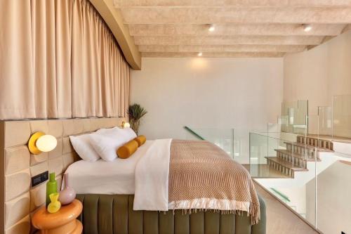 a bedroom with a bed and a glass wall at Maldives Beach Resort in Chao Lao Beach