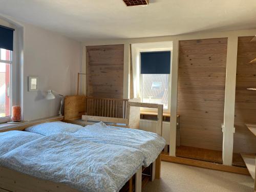 a bedroom with a large bed and a window at Großzügige Ferienwohnung nahe Berlin in Nauen