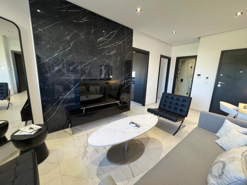 a living room with a couch and a fireplace at Only You in Sidi Daoud