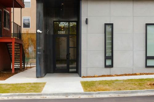 a building with black doors on the side of it at The Artesian in Denver