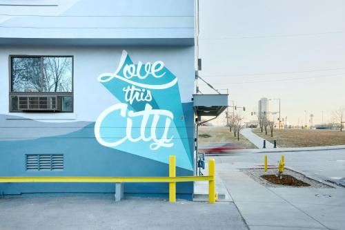a building with a sign that reads love this city at Sonder by Marriott Bonvoy Osage Apartments LoHi in Denver