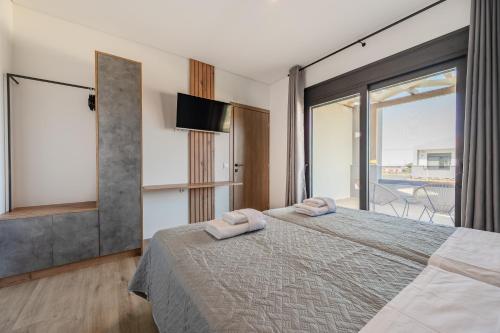 Ένα ή περισσότερα κρεβάτια σε δωμάτιο στο Rosy Villas Collection