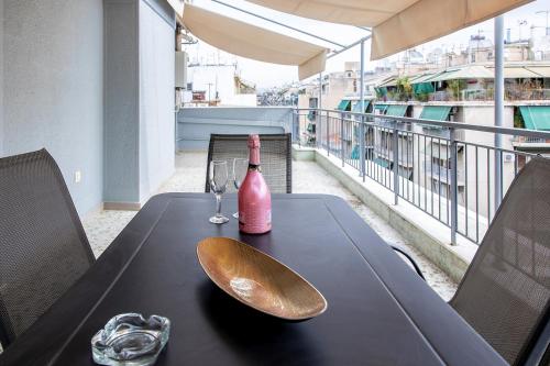 a table with a bottle of wine and a spoon at Aris123 by Smart Cozy Suites - Apartments in the heart of Athens - 5 minutes from metro - Available 24hr in Athens