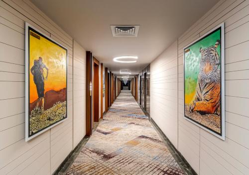a hallway with paintings on the walls at The Paradise Bliss - A Luxury Hotel & Spa in Udaipur in Udaipur