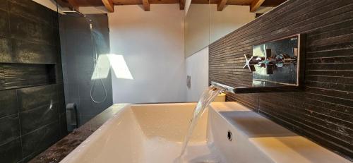 a bathroom with a sink with a faucet at Baita La Lidia in Sala Comacina