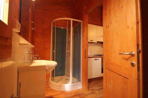 a bathroom with a glass shower and a sink at CAMPING CALATELLA parco di vacanza in Marina di Massa