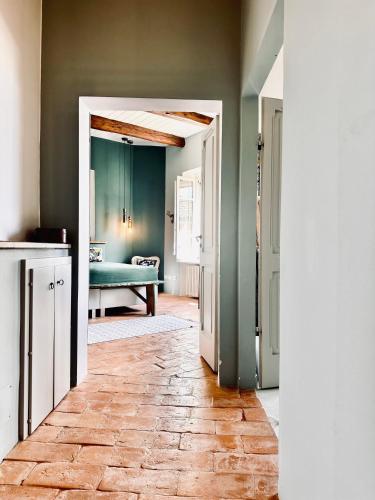 a hallway with a room with a bed and a kitchen at Palazzo Minzoni in SantʼIppolito