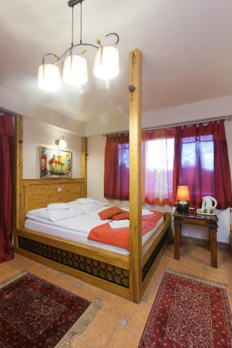 a bedroom with a large wooden bed in a room at Villa Cynamon Jacuzzi & Sauna in Wisła