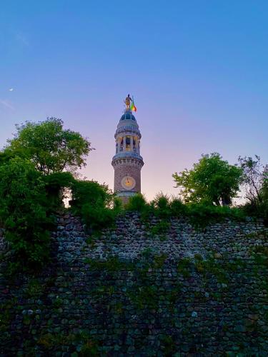 a tower with a clock on the top of it at La Chiocciola Viaggiatrice in Palazzolo sullʼOglio