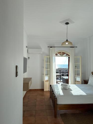 a bedroom with a bed and a view of the ocean at Limeni Studios in Limeni