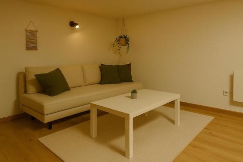 a living room with a couch and a table at Gesamtes Haus mit Garten - 100% Privatsphäre in Vienna