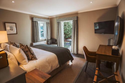 a hotel room with a bed and a desk and a desk at The Winning Post in Windsor