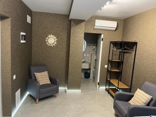 a living room with two chairs and a shelf at 77/5 in Chişinău