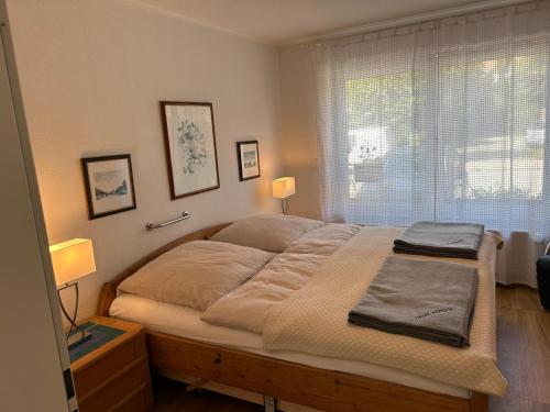 a large bed in a bedroom with a window at Haus Potosi, Travemünde in Lübeck
