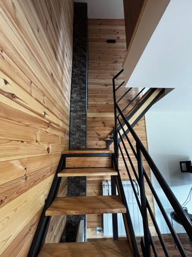 a staircase in a house with wooden walls at Zlatiborski biser in Suljagići