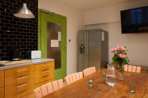 a kitchen with a wooden table with a green door at Schloss Mörlbach in Icking