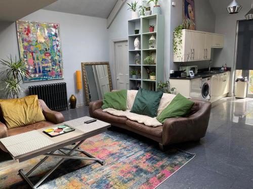 a living room with a couch and a table at Quirky house in Manchester