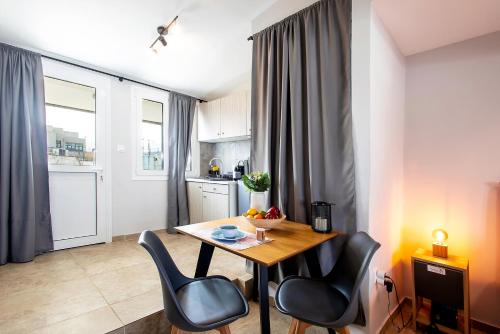 a small apartment with a dining table and chairs at Aris123 by Smart Cozy Suites - Apartments in the heart of Athens - 5 minutes from metro - Available 24hr in Athens
