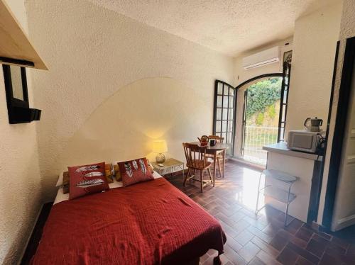 - une chambre avec un lit et une table avec un four micro-ondes dans l'établissement Studio 5 PORTO LUMIO, à Lumio