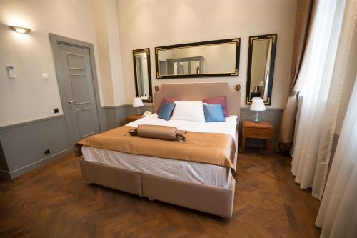 um quarto com uma cama grande e um espelho em Seven Rooms Boutique Hotel em Baku