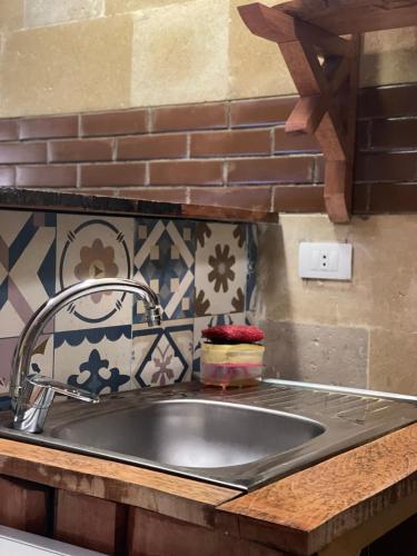 a kitchen sink with a metal faucet on a counter at Baraa house in Cairo