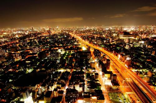 a view of a city at night at Art Hotel Osaka Bay Tower in Osaka