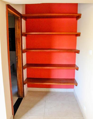a stairwell with orange and red walls at Pousada Cedro Ilha Comprida in Ilha Comprida