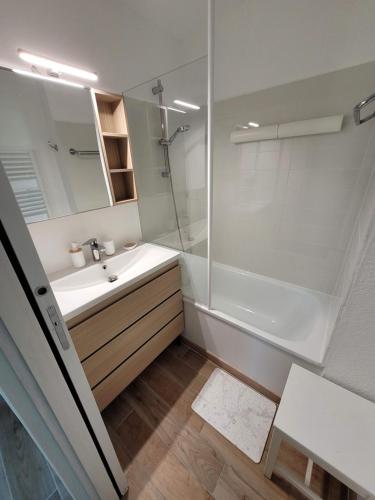 une salle de bain avec une douche, un lavabo et un miroir dans l'établissement Appartement, Port Bourgenay, Talmont-Saint-Hilaire, à Talmont-Saint-Hilaire