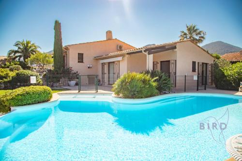 une piscine devant une maison dans l'établissement Sumptuous villa with sea view and its renovated outbuilding in the heart of, à Théoule-sur-Mer