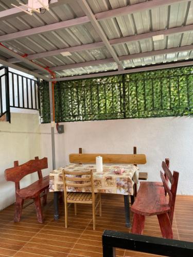a dining room with a table and two chairs at Nature Home Suites in Lunao