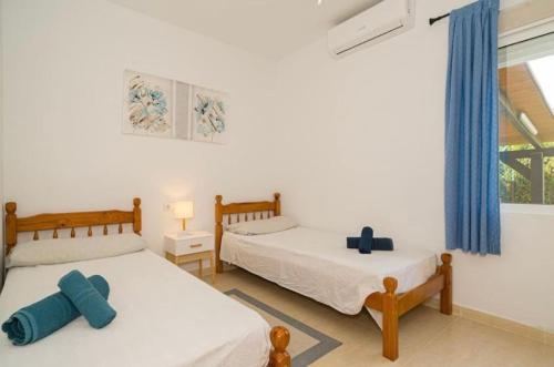 two twin beds in a room with a window at Casa Violetta in Alicante