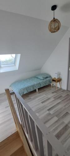 a bed in a white room with a window at maison ville in Chauny