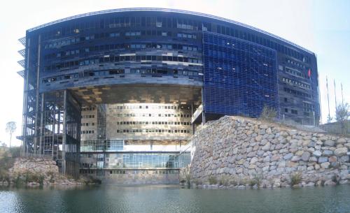 a large building in front of a body of water at Le Strasbourg Hotel in Montpellier