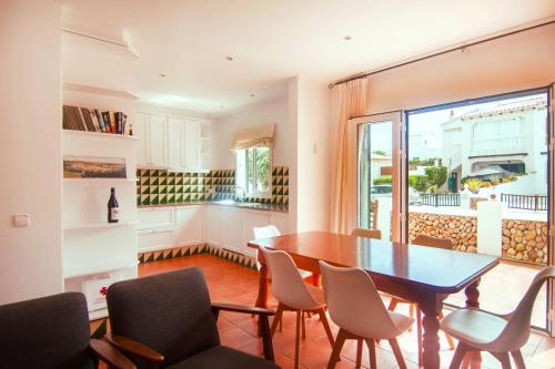 a dining room with a table and chairs at S Olivera in Port d'Addaia