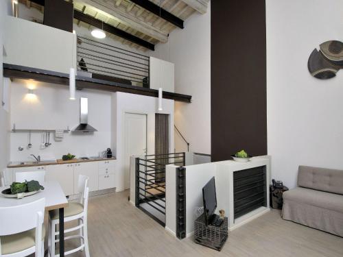 a kitchen and living room with a table and a couch at Villa Aruch in Florence