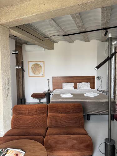 a bedroom with a bed and a couch at E64 Wieża Wrocław in Wrocław