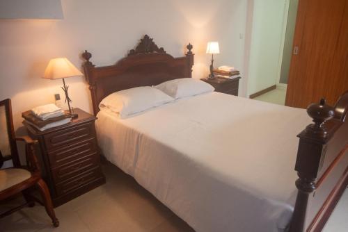 a bedroom with a large white bed with two night stands at Casa do Cédro in Vila Franca do Campo