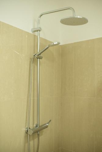 a shower with a shower head in a bathroom at Casa do Cédro in Vila Franca do Campo