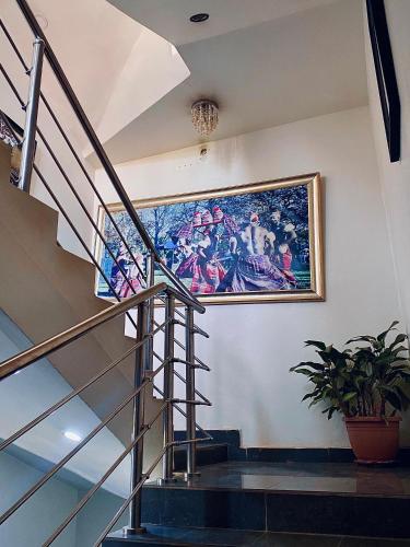 a painting on the wall of a building with a staircase at Starluxury Apartments and Suites in Mama