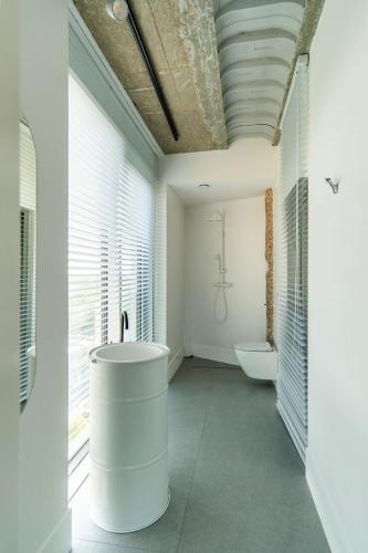 a bathroom with a sink and a tub in it at E64 Wieża Wrocław in Wrocław